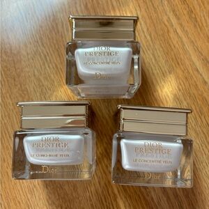 Three Dior empty eye cream jars